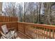 Relaxing deck with wood railing overlooking a lush, tree-filled backyard at 1175 Glenridge Pl, Atlanta, GA 30342