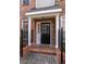 Inviting front entrance with brick walkway, columns, and a black front door with glass panes and sidelights at 1175 Glenridge Pl, Atlanta, GA 30342