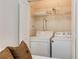 Convenient laundry area located in the bedroom, features a washer and dryer with storage at 1175 Glenridge Pl, Atlanta, GA 30342