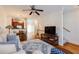 Bright living room with hardwood floors, ceiling fan, and an open layout that connects to the kitchen at 1175 Glenridge Pl, Atlanta, GA 30342