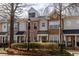 Charming townhomes featuring varied exteriors of brick, stone, and siding, creating a unique streetscape at 1175 Glenridge Pl, Atlanta, GA 30342