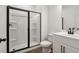 This bathroom includes a shower with a black frame and modern fixtures at 5384 Heron Bay Blvd, Locust Grove, GA 30248