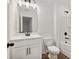 Bright bathroom features white cabinets, a single sink, and black hardware accents at 5384 Heron Bay Blvd, Locust Grove, GA 30248