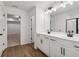 A bathroom with a double sink vanity, modern fixtures, and wood-look flooring at 5384 Heron Bay Blvd, Locust Grove, GA 30248