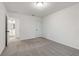 A carpeted bedroom with white walls and doors leading to the bathroom at 5384 Heron Bay Blvd, Locust Grove, GA 30248