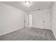 A bedroom with neutral carpet, white walls, and a connecting door at 5384 Heron Bay Blvd, Locust Grove, GA 30248