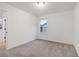 Cozy bedroom with large window, carpet floors, and white trim at 5384 Heron Bay Blvd, Locust Grove, GA 30248