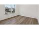 Bright bedroom featuring hardwood floors and a large window with outside view at 5384 Heron Bay Blvd, Locust Grove, GA 30248