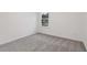 Carpeted bedroom with window offers a bright and neutral space at 5384 Heron Bay Blvd, Locust Grove, GA 30248