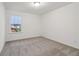 Bedroom with neutral carpet and window offering outside view at 5384 Heron Bay Blvd, Locust Grove, GA 30248