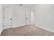 Bedroom with neutral carpet and white walls, featuring closet and doorway at 5384 Heron Bay Blvd, Locust Grove, GA 30248