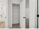 Walk-in closet with shelving and a view to the bathroom and shower at 5384 Heron Bay Blvd, Locust Grove, GA 30248