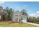 Two-story home with brick and siding, complemented by a green lawn, showcasing suburban charm at 5384 Heron Bay Blvd, Locust Grove, GA 30248