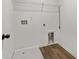 This laundry room has a wood floor and connections for a washer and dryer at 5384 Heron Bay Blvd, Locust Grove, GA 30248