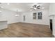Open-concept living room featuring hardwood floors, fireplace, and large windows at 5384 Heron Bay Blvd, Locust Grove, GA 30248