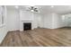 Spacious living room features a fireplace, large windows and hardwood floors at 5384 Heron Bay Blvd, Locust Grove, GA 30248