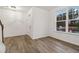 Bright living room with hardwood floors featuring a large window with an outside view at 5384 Heron Bay Blvd, Locust Grove, GA 30248