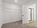 Walk-in closet features metal shelving and neutral carpet, conveniently located near the bathroom at 5384 Heron Bay Blvd, Locust Grove, GA 30248