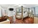 Bedroom featuring a canopy bed, hardwood flooring, and modern decor at 6219 Wurtenburg Ct, Stone Mountain, GA 30087