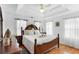 Cozy bedroom featuring a large bed, hardwood floors, and natural light at 6219 Wurtenburg Ct, Stone Mountain, GA 30087