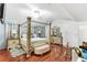 Spacious bedroom featuring a four-poster bed, ceiling fan, and hardwood floors at 6219 Wurtenburg Ct, Stone Mountain, GA 30087
