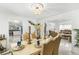 Formal dining room boasts luxury table set, elegant chandelier, and marble floors at 6219 Wurtenburg Ct, Stone Mountain, GA 30087