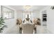 Dining room view features a luxury table setting, marble floors, and modern decor at 6219 Wurtenburg Ct, Stone Mountain, GA 30087