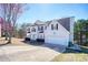 View of two-story home showcasing a two-car garage and landscaping at 6219 Wurtenburg Ct, Stone Mountain, GA 30087