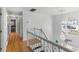 Well-lit hallway features hardwood floors, modern chandeliers, and large windows at 6219 Wurtenburg Ct, Stone Mountain, GA 30087