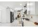 Stylish kitchen with white cabinetry, stainless steel appliances, and stone countertops at 6219 Wurtenburg Ct, Stone Mountain, GA 30087