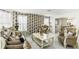 Living room featuring marble floors, large windows and stylish wallpaper at 6219 Wurtenburg Ct, Stone Mountain, GA 30087