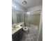 Bathroom features a single sink vanity, tile flooring, and a shower over the tub at 498 Prince Of Wales, Stone Mountain, GA 30083
