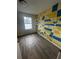 Bright bedroom offers wood floors, natural light, and hand painted accent wall at 498 Prince Of Wales, Stone Mountain, GA 30083