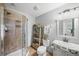 Cozy bathroom boasts tiled shower, vintage vanity, and modern fixtures with a decorative ladder shelf at 7880 Brands Hatch Blvd, Cumming, GA 30040