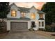 Charming two-story white brick home with a two-car garage and classic architectural details at 7880 Brands Hatch Blvd, Cumming, GA 30040