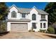 Charming two-story home with a manicured lawn and attached two-car garage at 7880 Brands Hatch Blvd, Cumming, GA 30040