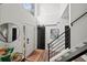 Entryway showcasing high ceilings, wood floors, a barn door, and contemporary staircase design at 7880 Brands Hatch Blvd, Cumming, GA 30040