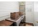 Convenient laundry room features a front-load washer, decorative wallpaper, and open shelving at 7880 Brands Hatch Blvd, Cumming, GA 30040
