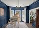 Elegant living room with a grand piano, bay window, and sophisticated decor at 7880 Brands Hatch Blvd, Cumming, GA 30040
