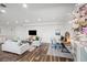 Spacious living room with hardwood floors, neutral paint, comfortable seating, and a mounted television at 7880 Brands Hatch Blvd, Cumming, GA 30040