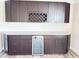 Close-up of bar cabinets with granite countertop, beverage cooler and wine rack at 3988 Two Bridge Drive, Buford, GA 30519