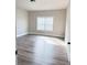 Well-lit bedroom with laminate flooring and a bright window for natural light at 3988 Two Bridge Drive, Buford, GA 30519