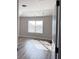 Bright bedroom featuring wood-look flooring, neutral walls, and a sun-lit window at 3988 Two Bridge Drive, Buford, GA 30519