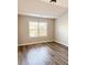 Bedroom with neutral walls, wood-look flooring, and a window providing ample natural light at 3988 Two Bridge Drive, Buford, GA 30519