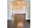 Bright dining room featuring hardwood floors and custom built-in cabinets with display shelving at 3988 Two Bridge Drive, Buford, GA 30519