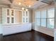 Bright dining room featuring elegant built-in cabinetry, coffered ceilings and large windows at 3988 Two Bridge Drive, Buford, GA 30519