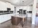 Bright kitchen with white cabinets, granite countertops, an island with seating, and wood flooring at 3988 Two Bridge Drive, Buford, GA 30519