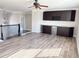 Spacious living room featuring dark brown bar cabinets, wine rack, beverage cooler and laminate flooring at 3988 Two Bridge Drive, Buford, GA 30519