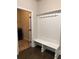 Mudroom with a built-in bench, coat hooks, and access to the laundry room at 3988 Two Bridge Drive, Buford, GA 30519