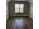 Spacious walk-in closet featuring hardwood floors, a window, and metal shelving at 3988 Two Bridge Drive, Buford, GA 30519